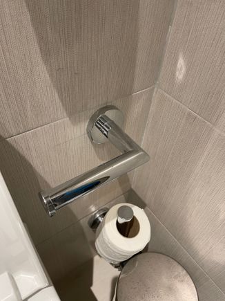 You have to bend your arm to reach the toilet paper