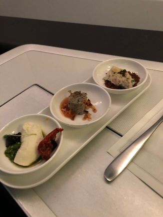 (front to back) feta cheese with lovage pesto and smoked tomato, duck confit with caramelised hazelnut and orange ginger compote, Dorset crab with Oscietra caviar and pumpernickel