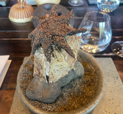 "Sea Sunstar" of Jiba (the starfish is made of fish and coated in edible sand covering a warm soup below it)
