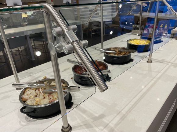 The only saving grace is that BA is clearly catering at AA’s JFK lounge. Real eggs, real bacon, Cumberland sausage, bean (for those who want to toot mid-flight) and potatoes with onions). Not shown, real NY mini bagels and real cream cheese. Yes, this was where I ate.