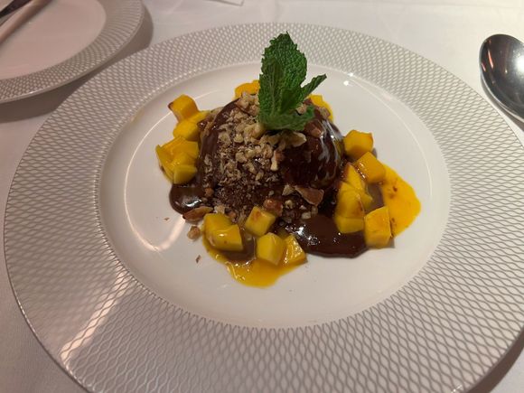 Chocolate walnut soufflé, chocolate sauce, fresh mango