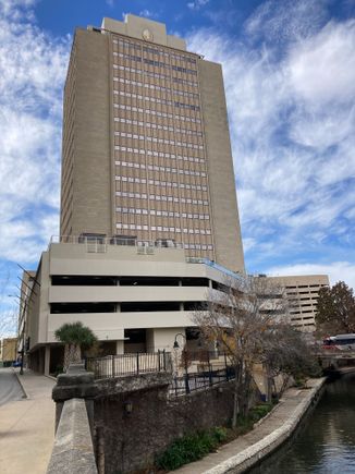 The hotel tower + parking garage, left is east pecan street, right the San Antonio riverwalk