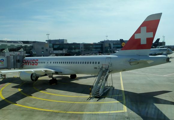 The SWISS plane to Geneva waiting at the gate 