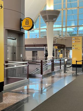 Walk over the west<->east walkway and take the escalator or elevator down to TSA PreCheck.