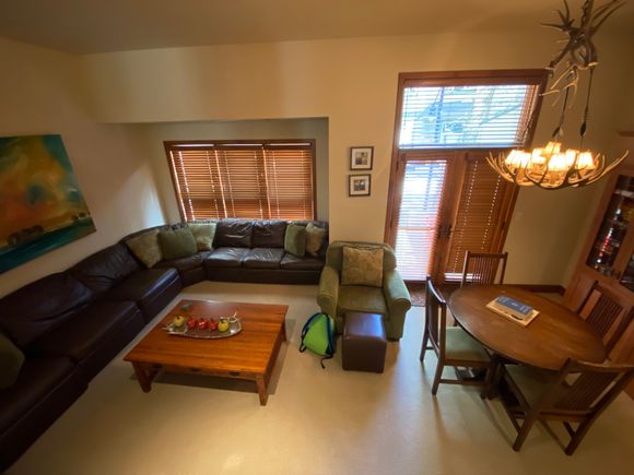 Cozy living room with good, but well worn furniture and personal items from the owner