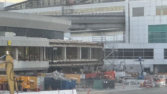 Facade being removed from the 1979 exterior, in the area in front of the Centurion lounge and near the  T3 to -G connector