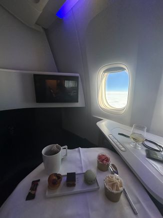 I was really surprised by the size of the table, it is really really small, once the tray is there you can put anything else. Even the purser I got was very surprised by the small size( it was her flight on this cabin)