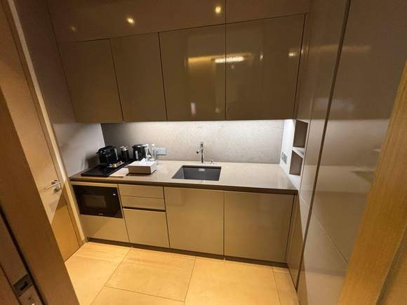 Kitchenette with a microwave, sink, and refrigerator.