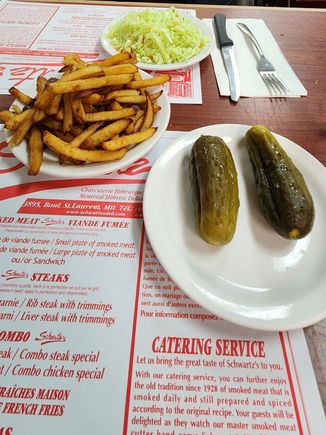 Cole slaw, fries, and sour pickles at Schwartz's Delicatessen