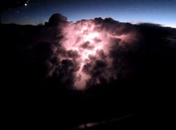 A cloud is split apart by lightning - OW AA930 from GRU to MIA on approach to MIA.