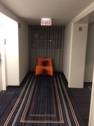 Hallway looking towards funky orange chair