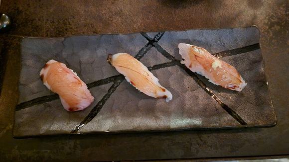 dry aged yellowtail on the left and a mackerel on the right. sorry, don't remember the center