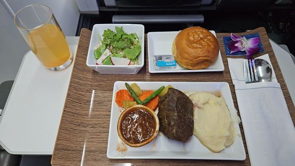 The beef was a bit chewy from being heated. No dessert was given but was offered. Not sure if there was any loaded or they ran out. Coffee was served before the dessert offer and then drink service was non existent. A snack basket was offered towards the end of the flight.