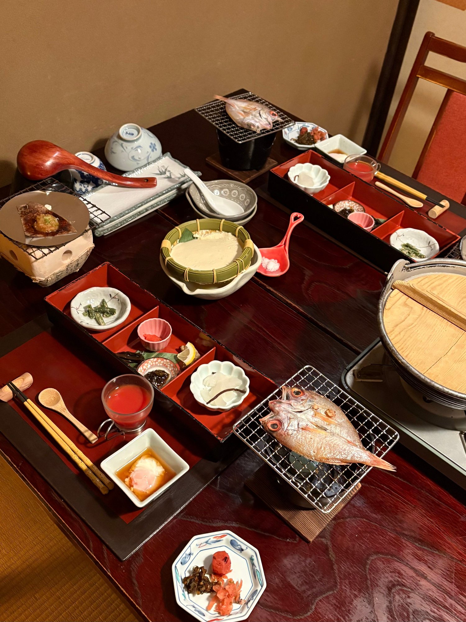Breakfast: tomato juice, small whole river fish we grilled ourselves, soup with noodles and vegetables, miso soup, sticky rice with miso, pickles, fresh soft tofu, egg cooked in hot spring water, cantaloupe. 