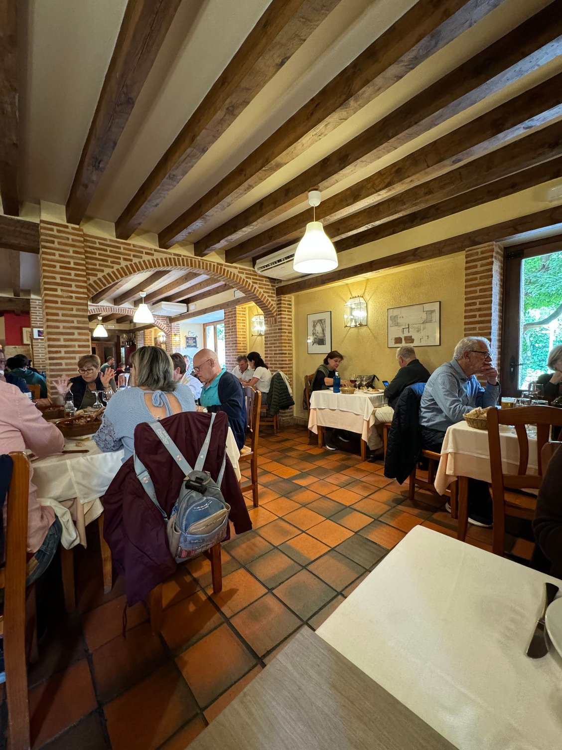 La Corrala de la Joaquina on a Sunday afternoon, everyone enjoying its baby roast lamb, or lechazo.