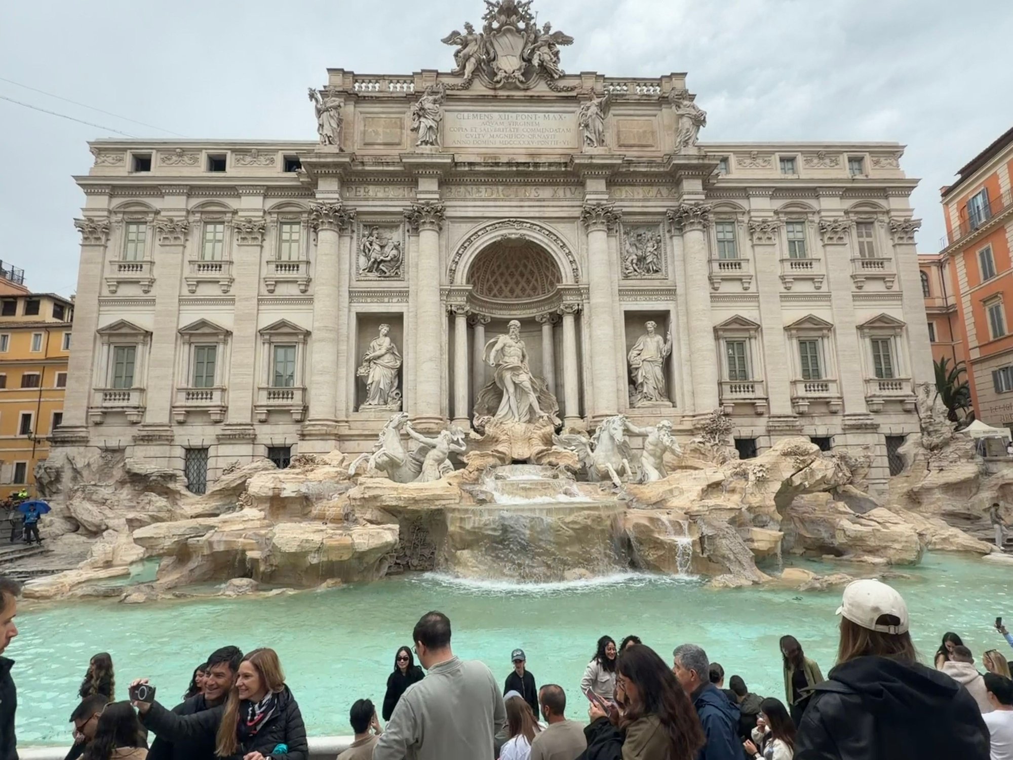 “The Trevi Fountain in Rome is a world-famous Baroque masterpiece known for its dramatic sculptures, particularly the central figure of Oceanus, and the tradition of tossing coins into its waters for good luck, ensuring a return to Rome”