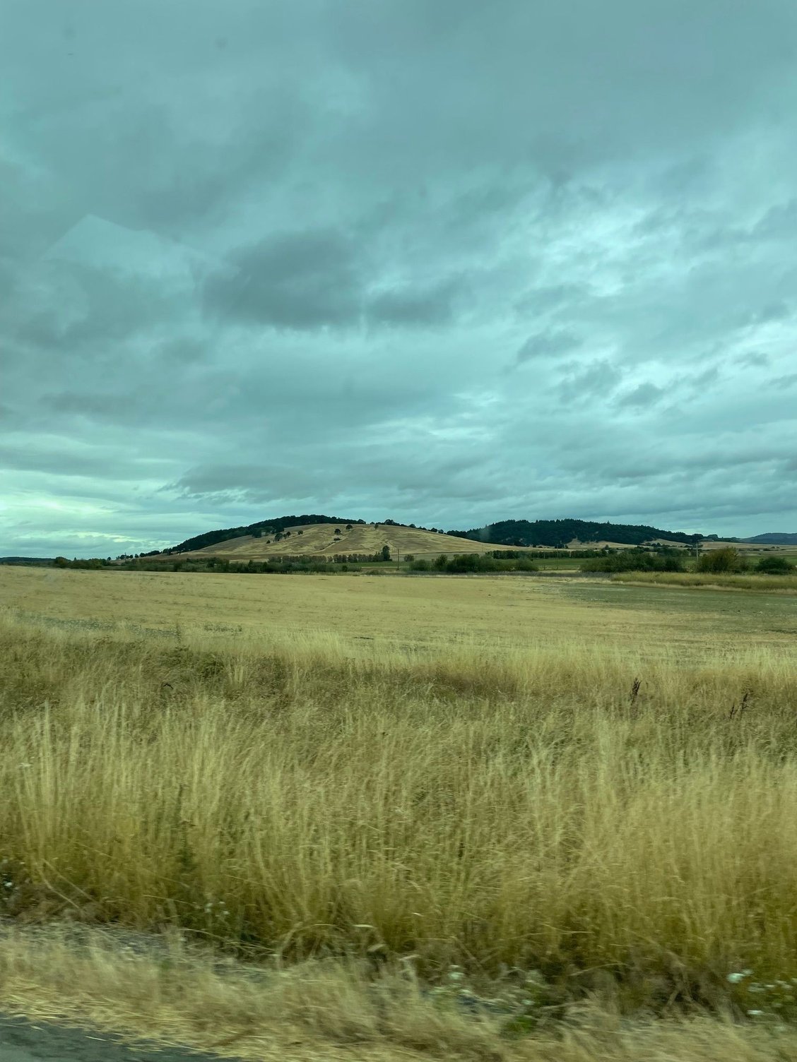 This is what we saw from the road, long fields with hills / mountains in the back.