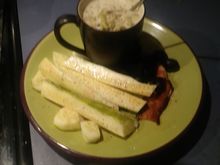 Cream of broccoli soup with an English cuke and black olives.