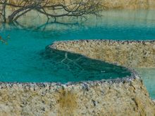 Near Songpan, one finds Huanglong park ('yellow dragon'), a sort of twin geographical attraction with Jiuzhaigou. Its main feature are travertines. Think Yellowstone or Pammukele in Turkey. Calcite deposits combine with bacteria and algae to create characteristic blue/green ponds. cable car is the only way up into this scenic mountain wonderland.