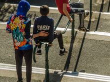 Boys sliding down with a handrail.