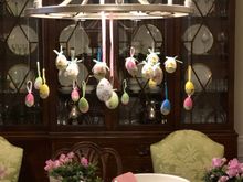 Paper mache eggs suspended from the chandelier which, because two leaves are in, is no longer centered on the table! 