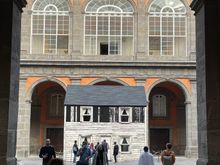 View of the interior space of the Royal Palace. The small house within the space is the one-time home of US civil rights heroine, Rosa Parks. The house had been set for demolition, bought by her niece for $500, and donated to an artist from Berlin. It's now reconstructed in Naples, where it stands, accompanied by an audio soundtrack created as a tribute to George Floyd. 