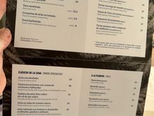 STARTERS; CRUDO (RAW DISHES); SHORT LIST OF CLASSIC DISHES; GRILLED DISHES. 
  AT LOWER RIGHT IS A DIAGRAM OF A TUNA, IDENTIFYING SOME OF THE PARTS USED BY THE KITCHEN.  These are the cartas offered to the diners at the bar, but all of the dishes (from the longer menu) can also be taken while seated at the bar.
A a single diner, I preferred to eat at the bar, so I could watch the action.   Bar tables are high-top, so keep that in mind if that type of seating is uncomfortable for you.