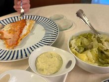 At left, virrey, a prized white-fleshed saltwater fish recognizable for its very large eye and red skin; served with the famous local potatoes and greens