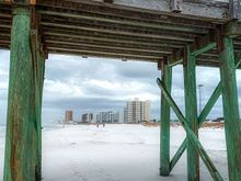 Pier structure framing the nearest buildings 