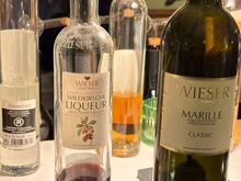 CLOSE UP OF VAST VARIETY OF AFTER-DINNER DRINKS