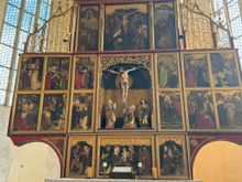 This triptych has 28 panels. The crucifixion scene in the middle is three dimensional