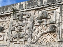 This is from the Nunnery Quadrangle.  There is a giant serpent and a person's head coming out of the mouth.