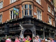 Walked past this pub and a soccer riot was going on, riot of fun that is, all of these guys were blocking the streets singin