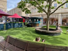 A little playground in the middle of the mall. Nice idea the "grass" angles up so you sit against it.