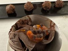 Chocolate gelato with bits of fruit rind and, in back,  
biscotto Cogliesse, made from ground almonds, sour am arena jam, and cinammon (not very sweet)