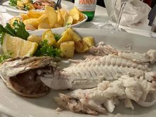 I chose a type of bream from he display of fish and it was excellent.   75 euro per kilo seems to be the going rate around here.  This grilled fish, which I had trouble finishing,, cost 28.50 euro and came with those lovely roasted potatoes.  Total bill for two=58 euro, with wine and water and coper to.  Recommend.