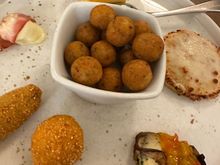 On the second platter, in the center: Addictive "polpettinne di pane," the classic dish of the cucina povera of Puglia and Basilicata; two types of fried cheeses; a wedge of frittata; an "enclosed" focaccia; more eggplant; capocola from Martina, etc. (Cannot remember every one I detail, an by now we are both stuffed!!)