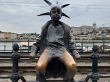 The Little Princess statue on the Danube promenade - the artist was inspired by his eldest daughter who enjoyed playing dress-up - wearing a princess costume and a crown made out of newspaper