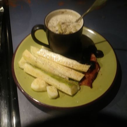 Cream of broccoli soup with an English cuke and black olives.