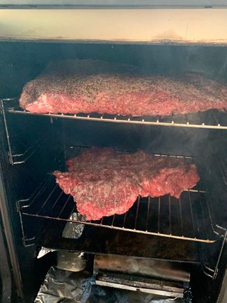 The flat brisket on top and a burnt ends to be on the bottom go into the smoker at 225° with oak and hickory chips providing the smoke.