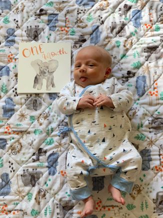 My grandson last week at one month. My sister made his comfy quilt.