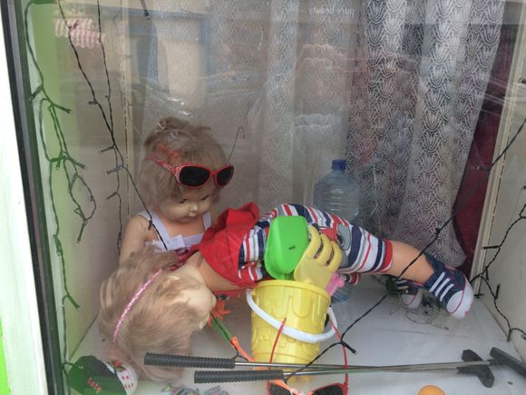 Shop window in Dingle, Ireland. The look on the sitting doll’s face is so appropriate, I think.