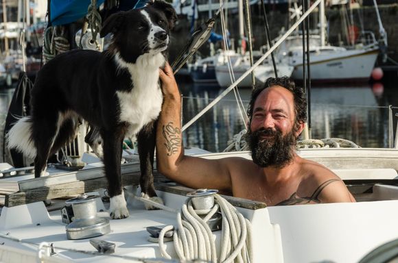Lulu and her friendly owner in the modern marina. He looked like we felt: half-awake from loss of sleep. Above him was the massive, modern Grand Pont bridge.