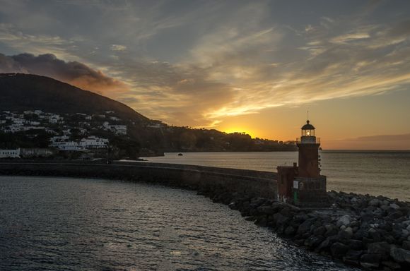 Arriving safe and sound (except for one cracked lens cover) back at Ischia's Porto. Its faro guides us in. Mt Epomeo rises 800m just behind. A couple months prior, its slopes had experienced a terrible mudslide. People lost their lives. One of our taxi driver's elderly in-laws barely escaped, but lost everything. We were told differing reasons as to the cause, from unenforced municipal buildings laws to a simple act of Mother Nature--she always bats last.
*next: the Aragonese Castle