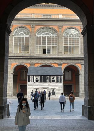 View of the interior space of the Royal Palace. The small house within the space is the one-time home of US civil rights heroine, Rosa Parks. The house had been set for demolition, bought by her niece for $500, and donated to an artist from Berlin. It's now reconstructed in Naples, where it stands, accompanied by an audio soundtrack created as a tribute to George Floyd. 