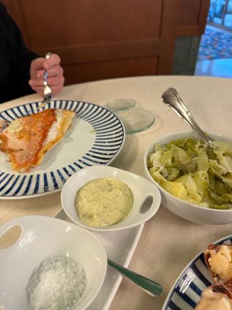 At left, virrey, a prized white-fleshed saltwater fish recognizable for its very large eye and red skin; served with the famous local potatoes and greens