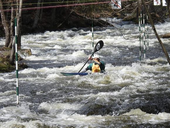 The striped poles are the race gates. Whitewater conditions are created by a controlled release at the dam.