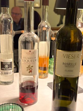 CLOSE UP OF VAST VARIETY OF AFTER-DINNER DRINKS