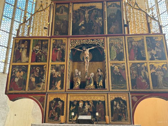 This triptych has 28 panels. The crucifixion scene in the middle is three dimensional