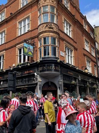 Walked past this pub and a soccer riot was going on, riot of fun that is, all of these guys were blocking the streets singin